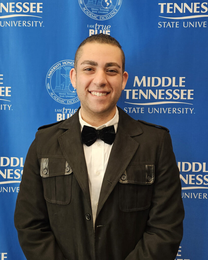 smiling man in black bowtie wearing black jacket