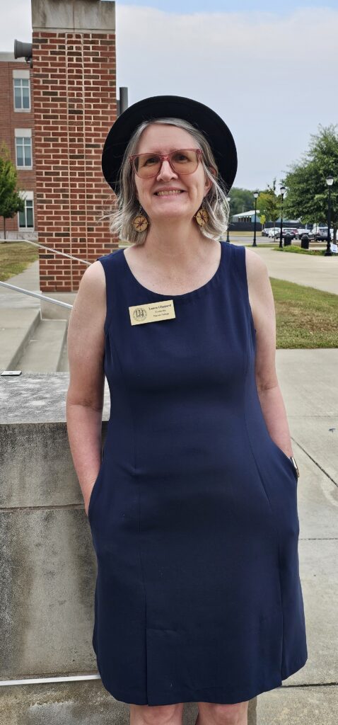 MTSU Honors Advisor Laura Clippard, woman in blue dress and hat outside
