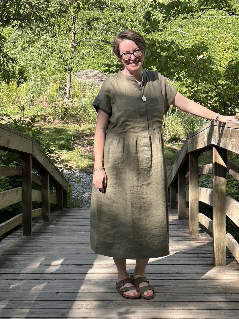 woman standing on bridge outdoors, smiling and friendly